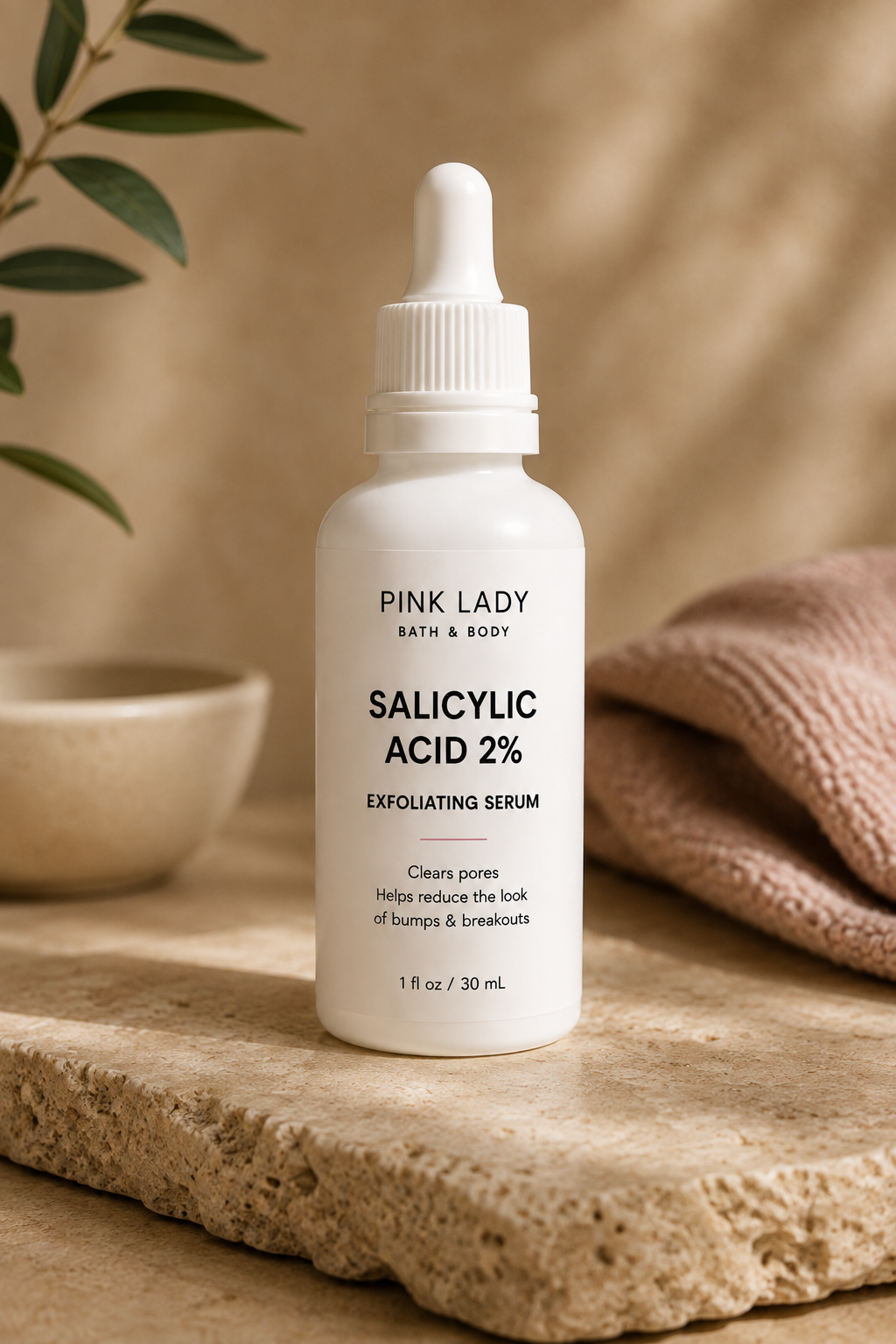 Pink Lady Salicylic Acid 2% Exfoliating Serum in a white dropper bottle on a warm neutral skincare background.