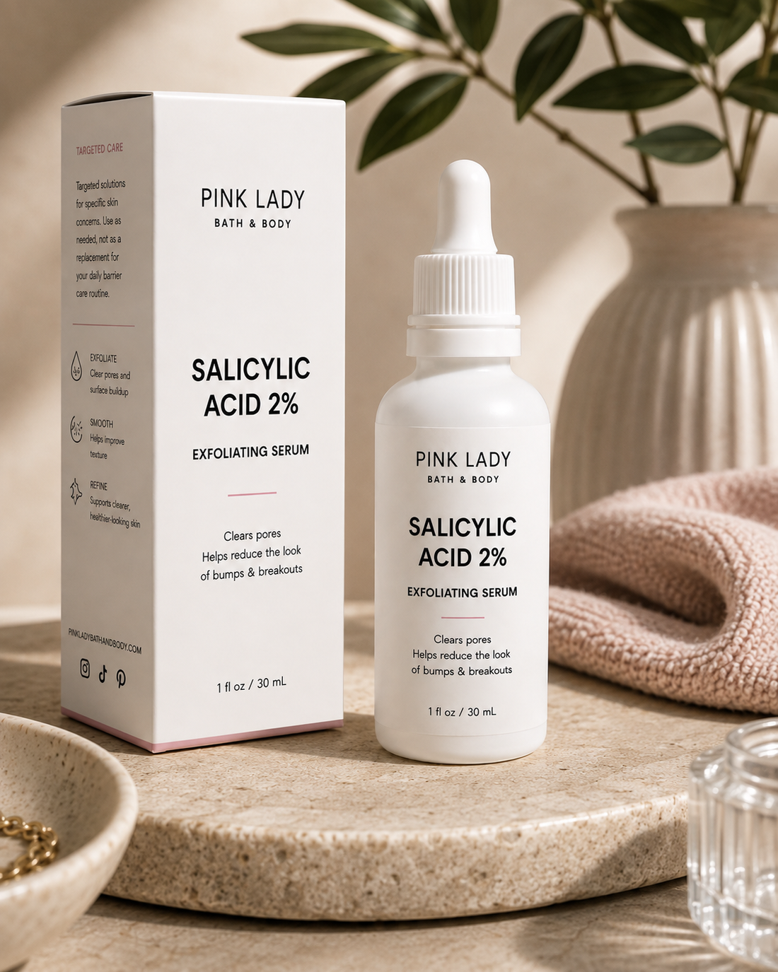 Pink Lady Salicylic Acid 2% Exfoliating Serum with retail box in a skincare lifestyle setting for clogged pores and rough texture.